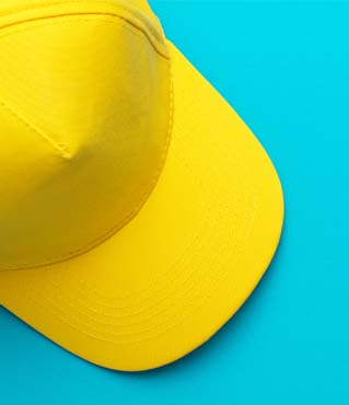 top-view-of-yellow-baseball-cap-over-turquoise-blu-2022-01-28-07-16-11-utc.jpg